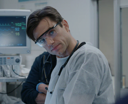 Doctor in Safety Goggles in Front of Monitor Saying 102