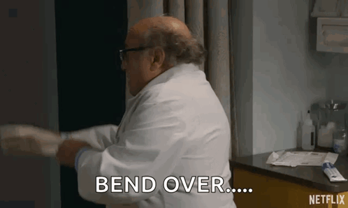 Doctor in White Coat Bending Patient's Arm