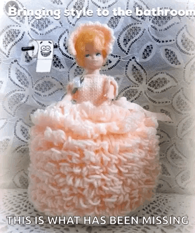 Doll in Pink Dress Sitting on Toilet Paper Caption Bringing Style to the Bathroom