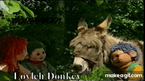 Dolls Standing Next To Donkey In Forest GIF