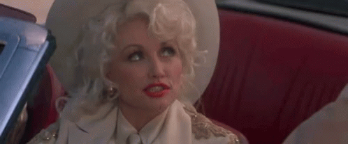 Dolly Parton Looking Up Wink GIF