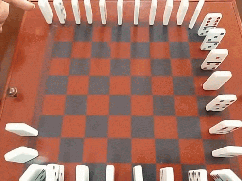 Dominoes On A Red And Black Checkered Board With A Diagonal Line Of Dominoes GIF