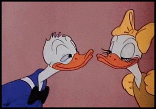 Donald Duck And Daisy Duck Are Kissing Each Other In A Cartoon GIF