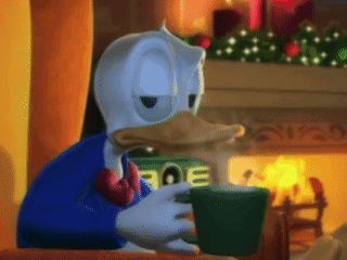 Donald Duck Sitting by Fireplace Drinking From Green Cup