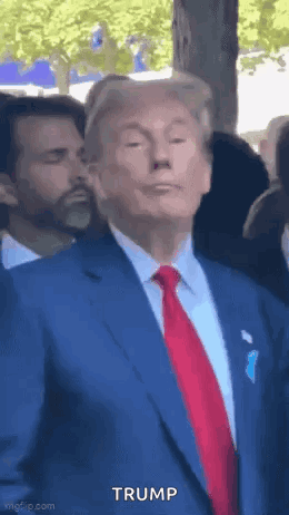 Donald Trump in Blue Suit and Red Tie Before Crowd