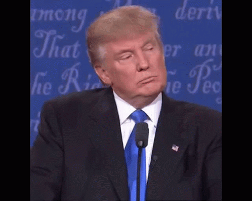 Donald Trump Is Giving A Speech In Front Of A Microphone And Making A Funny Face . GIF