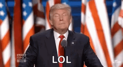 Donald Trump Is Giving A Speech In Front Of A Microphone And Says Lol . GIF
