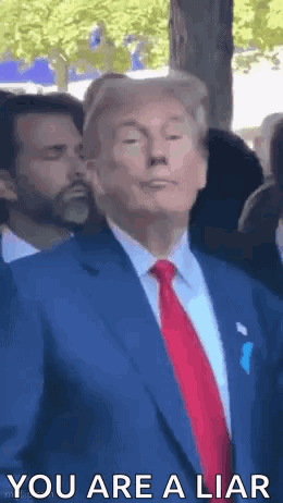 Donald Trump Is Wearing A Blue Suit And Red Tie And Is Standing In Front Of A Crowd . GIF