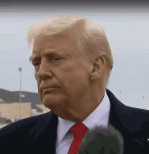 Donald Trump Is Wearing A Suit And Tie And Is Talking Into A Microphone GIF