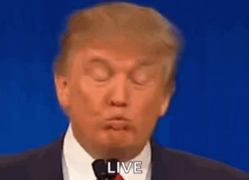 Donald Trump Making Funny Face Into Microphone in Suit and Tie