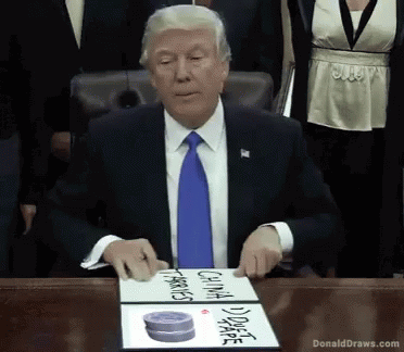 Donald Trump Sitting at Table with DonaldDraws.com Sign