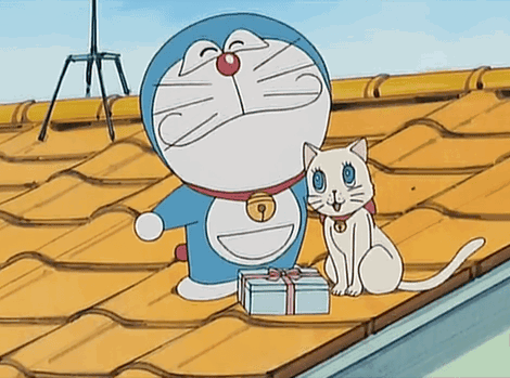 Doraemon And A White Cat Are On A Roof With A Gift Box GIF
