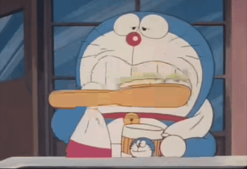 Doraemon Is Brushing His Teeth With A Toothbrush GIF