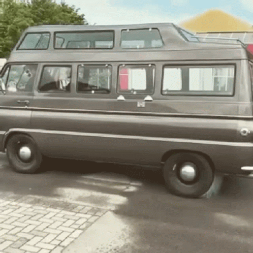 Double Decker Van Parked on Brick Driveway