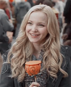 Dove Cameron Holding Candy While Smiling GIF