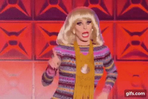 Drag Queen Dancing in Colorful Sweater and Scarf on Stage