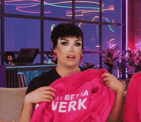Drag Queen Holding Pink Shirt Saying La Betta Verk
