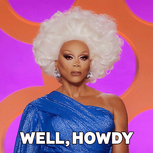 Drag Queen in Blue Dress and White Wig Saying Well Howdy