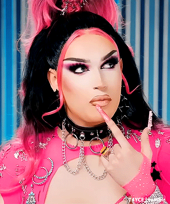 Drag Queen in Choker and Gloves Pointing at Lips