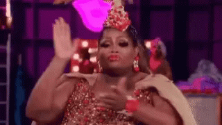 Drag Queen in Crown High-Fiving While Dancing