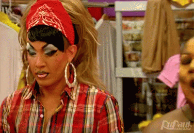 Drag Queen In Plaid Shirt And Red Bandana In Closet GIF