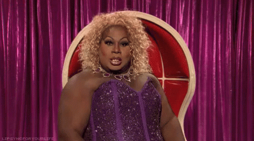 Drag Queen in Purple Dress Pointing