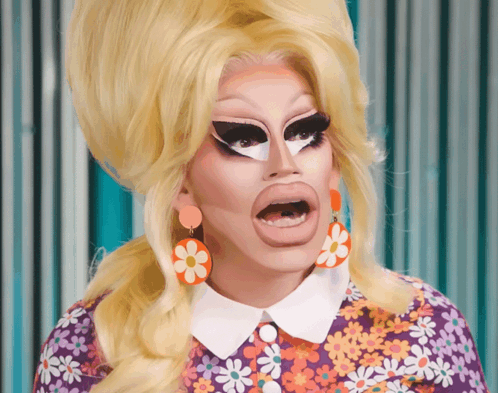 Drag Queen in Purple Shirt With Daisies and Earrings