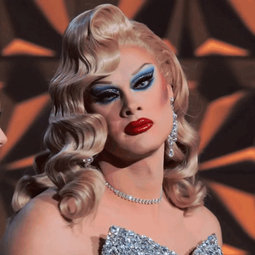 Drag Queen In Silver Dress And Necklace GIF