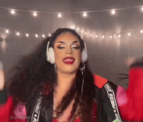 Drag Queen With Headphones and Red Jacket Dancing