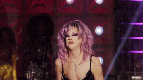 Drag Queen With Purple Hair Dancing On Stage GIF