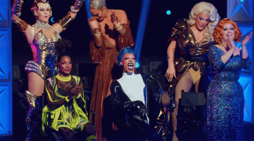 Drag Queens on Stage One With Blue Wig