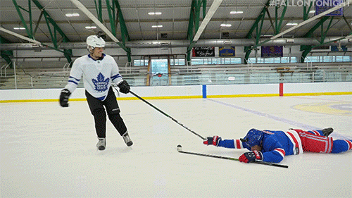 Dragging Another Player On Hockey Field GIF