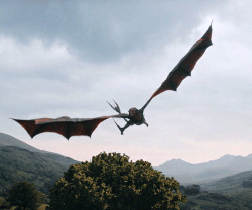 Dragon Flying Over Tree Through Cloudy Sky GIF