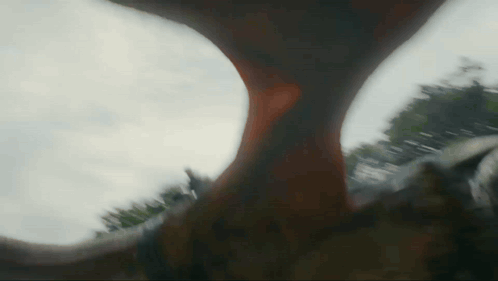 Dragon Tail Against Cloudy Sky With Trees GIF