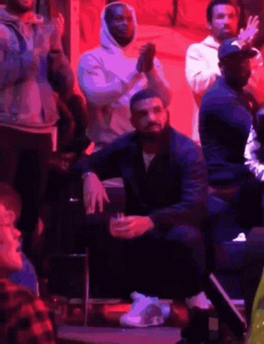 Drake Sitting in Stands with Drink
