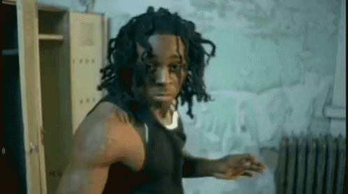 Dreadlocked Man Among Lockers and Radiator