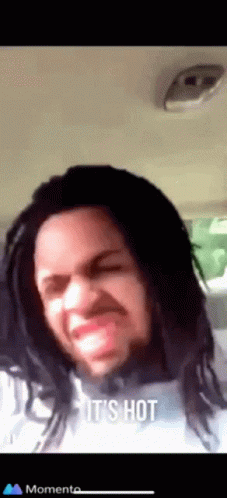 Dreadlocked Man Funny Face Saying It's Hot