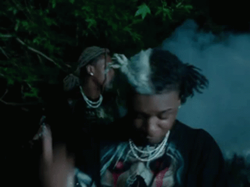 Dreadlocked Man in Black Skull Shirt and Necklace