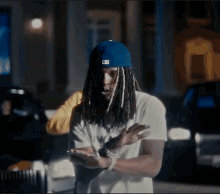 Dreadlocked Man in Blue Hat