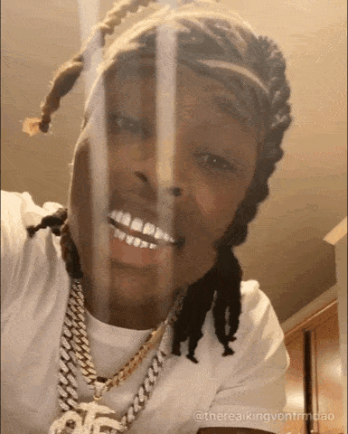 Dreadlocked Man in White Shirt Smiling at Camera