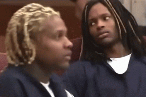 Dreadlocked Man Next to Man in Chair