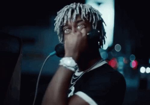 Dreadlocked Man Singing into Microphone with Headphones