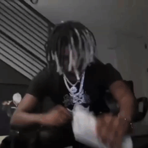 Dreadlocked Man Sitting on Couch Holding Money Bag