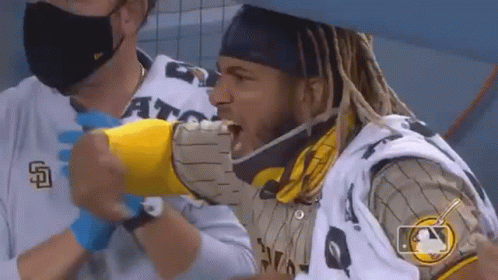 Dreadlocks Man Eating Hot Dog in Mask and Gloves