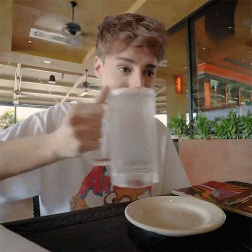 Boy Drinking Water Slowly On Glass GIF