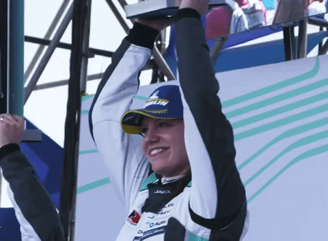 Driving Fast Car Racer Holding Winning Trophy GIF
