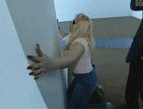 Drunk Girl Holding To The Wall GIF