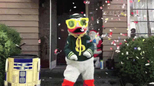 Duck Mascot Dancing With Falling Confetti GIF