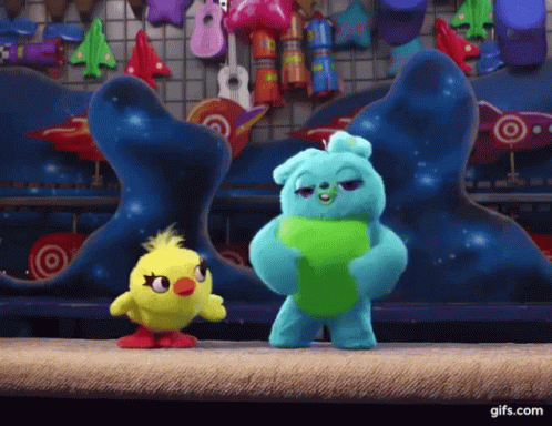 Ducky And Bunny From Toy Story Are Standing Next To Each Other On A Stage . GIF