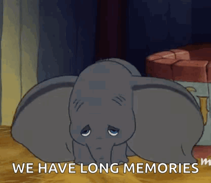 Dumbo From The Disney Movie Dumbo Is Laying Down On The Floor With His Eyes Closed . GIF